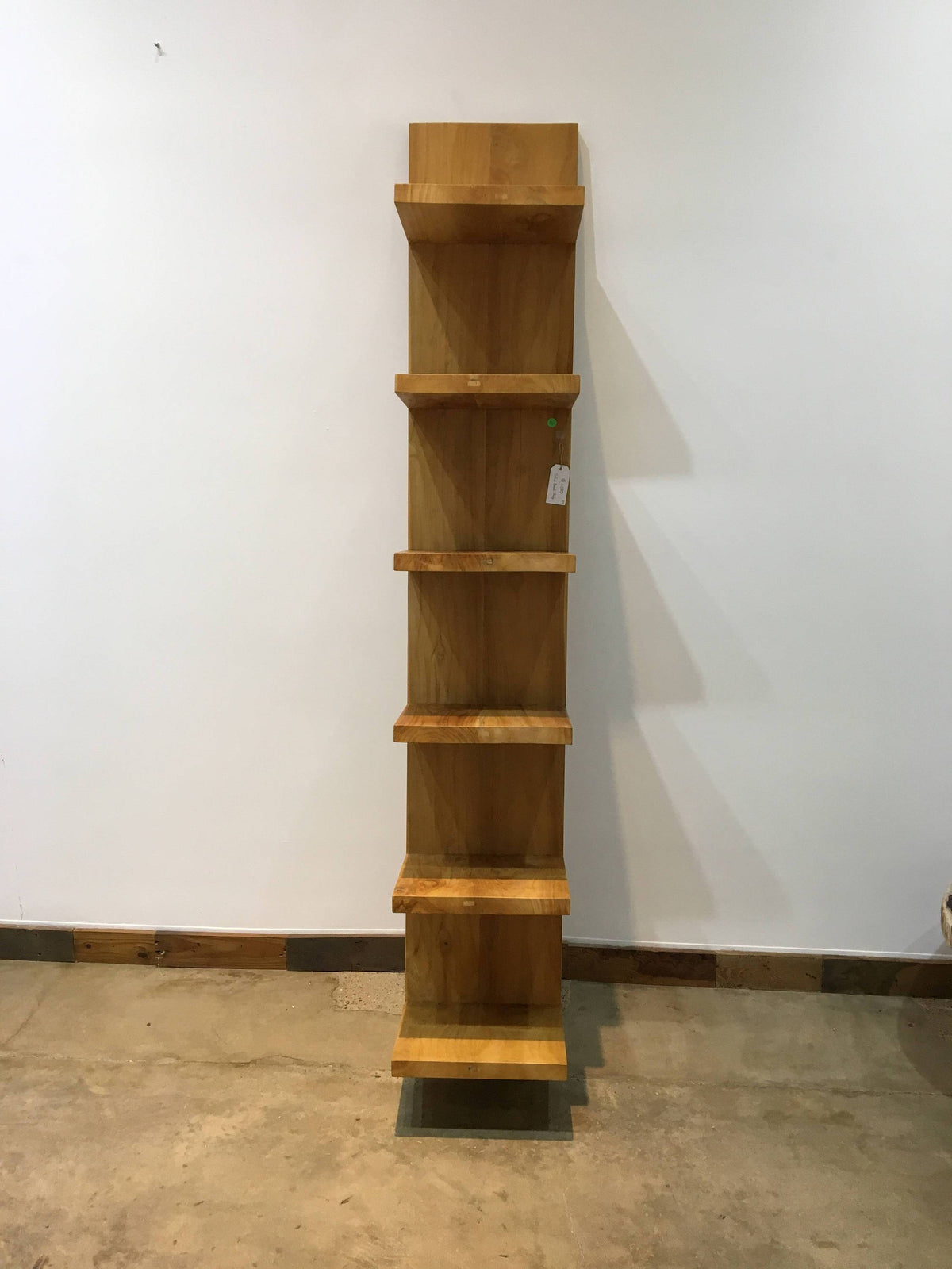 Modern primitive leaning bookshelf