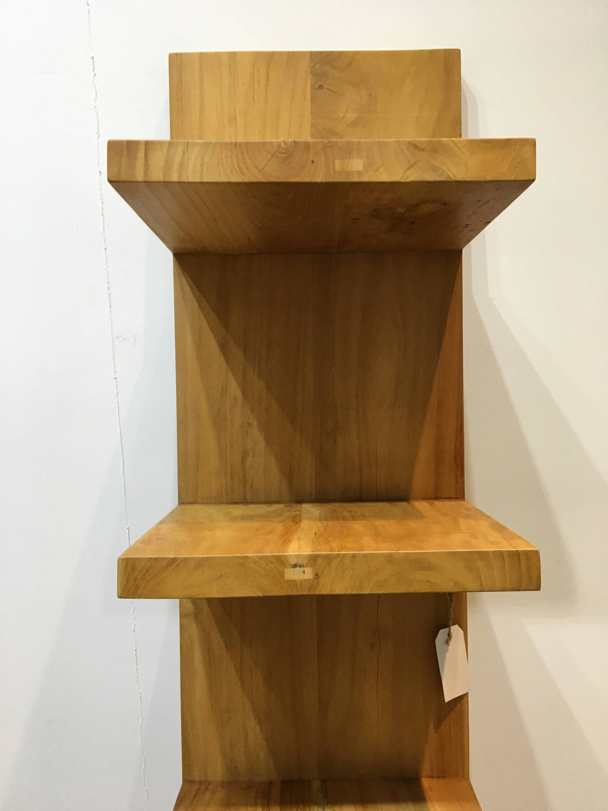 Modern primitive leaning bookshelf